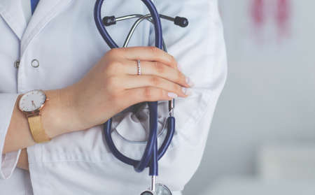 Smiling medical doctor woman with stethoscope in hospitalの写真素材