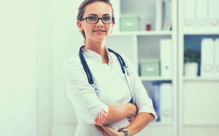 Woman doctor standing at hospitalの写真素材