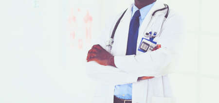 Happy afro man doctor portrait with arms crossedの写真素材