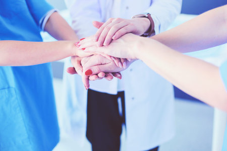 Doctors and nurses in a medical team stacking handsの写真素材