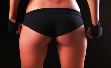 Portrait of young beautiful fitness woman, isolated on black backgroundの写真素材