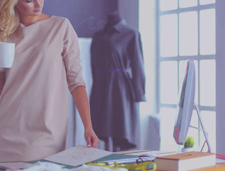 Fashion designer woman working on her designs in the studio.の写真素材