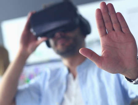 Young male software programmer testing a new app with 3d virtual reality glasses in office.の写真素材