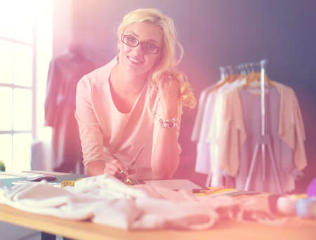 Fashion designer woman working on her designs in the studio.の写真素材