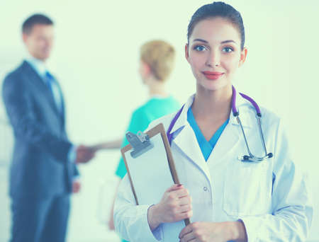 Attractive female doctor in front of medical groupの写真素材