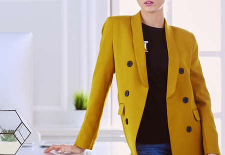 Portrait of a beautiful business woman standing near her workplaceの写真素材
