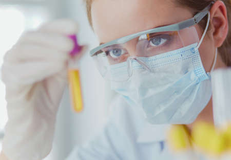 Researcher, doctor, scientist or laboratory assistant working with plastic medical tubes in modern lab or hospitalの写真素材