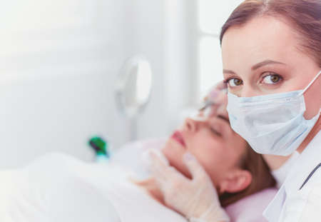 A young girl having red lips permanent makeup, micropigmentationの写真素材