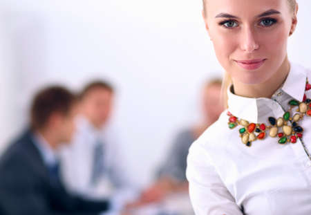 Portrait of a young woman working at office standing with folder . Portrait of a young woman. Business womanの写真素材