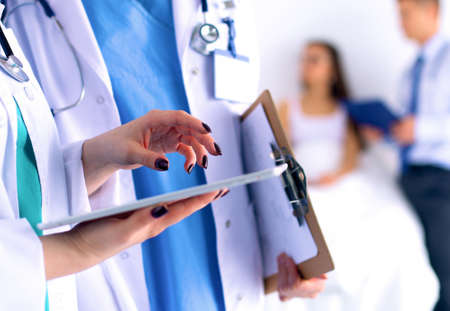 Young woman doctor holding a tablet pcの写真素材