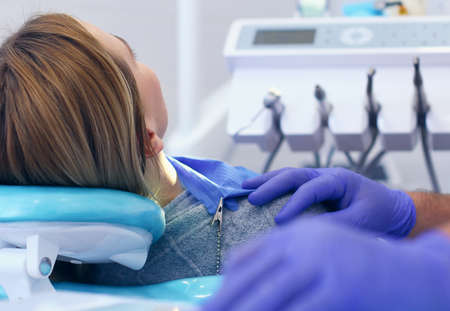 Detail of hand holding dental tools in dental clinic. Dentist Conceptの写真素材
