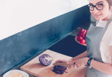 Young woman using a tablet computer to cook in her kitchenの写真素材