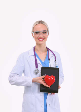 Young woman doctor holding a red heart, isolated on white background. Woman doctorの写真素材