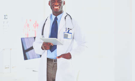Male black doctor worker with tablet computer standing in hospitalの写真素材
