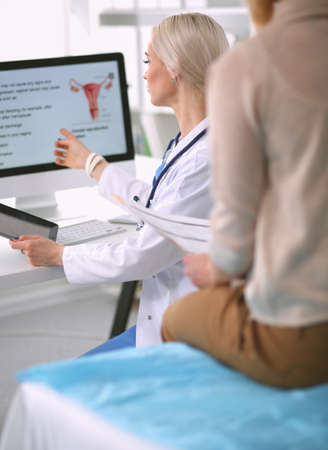Doctor and patient discussing something while sitting at the table . Medicine and health care concept. Doctor and patientの写真素材