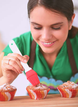 Woman is making cakes in the kitchenの写真素材