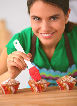 Woman is making cakes in the kitchenの写真素材