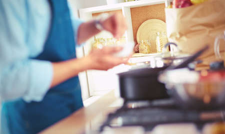 Man preparing delicious and healthy food in the home kitchenの写真素材