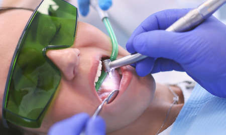 Dental team and patient at dentists surgeryの写真素材