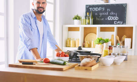 Man preparing delicious and healthy food in the home kitchenの写真素材
