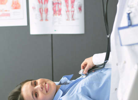 Doctor and patient discussing something while sitting at the table . Medicine and health care conceptの写真素材