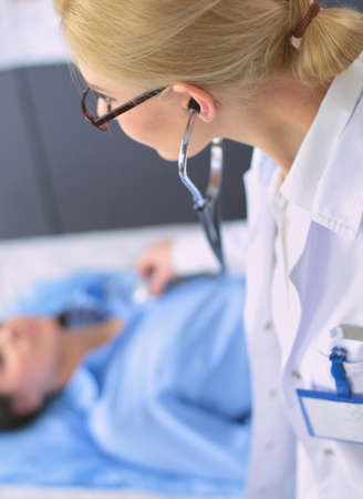 Doctor and patient discussing something while sitting at the table . Medicine and health care conceptの写真素材