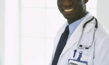 Male black doctor worker with tablet computer standing in hospitalの写真素材