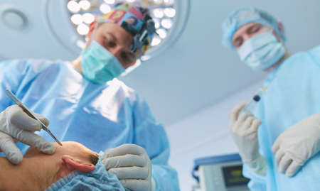 Man surgeon at work in operating roomの写真素材