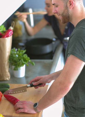 Couple cooking together in their kitchen at homeの写真素材