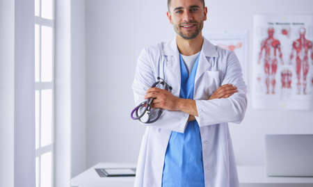 Young and confident male doctor portrait standing in medical offの写真素材