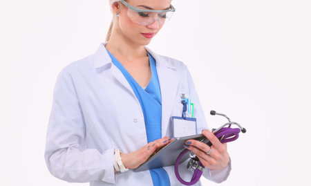 Female doctor using a digital tablet and standing on white background. Woman doctors.の写真素材