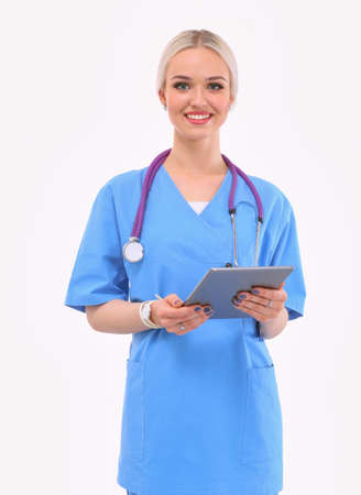 Female doctor using a digital tablet and standing on white background. Woman doctors.の写真素材