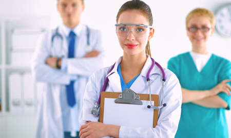 Attractive female doctor in front of medical groupの写真素材