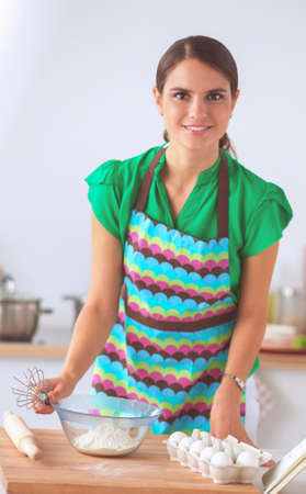 Woman is making cakes in the kitchenの写真素材