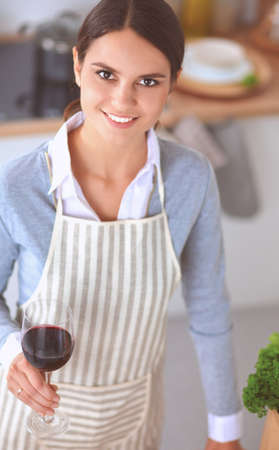 Woman making healthy food standing smiling in kitchenの写真素材