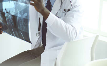 Portrait young african medical doctor holding patients x-rayの写真素材