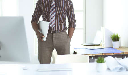 African american architect working with computer and blueprints in officeの写真素材