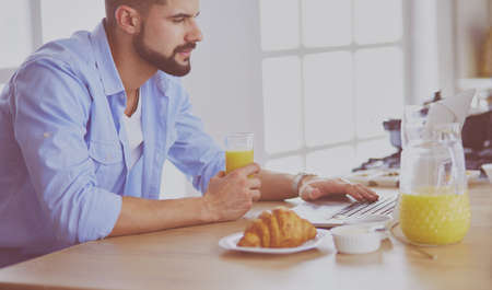 Man preparing delicious and healthy food in the home kitchenの写真素材