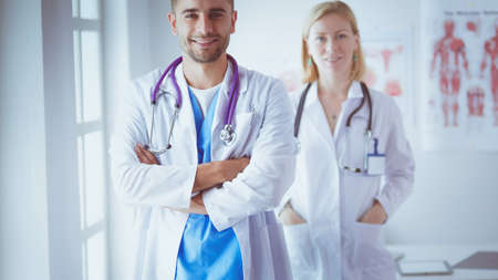 Young and confident doctors portrait standing in medical officeの写真素材