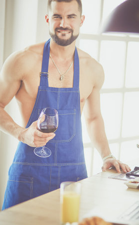 Man preparing delicious and healthy food in the home kitchenの写真素材