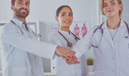 Doctors and nurses coordinate hands. Concept Teamwork in hospital for success work and trust in teamの写真素材
