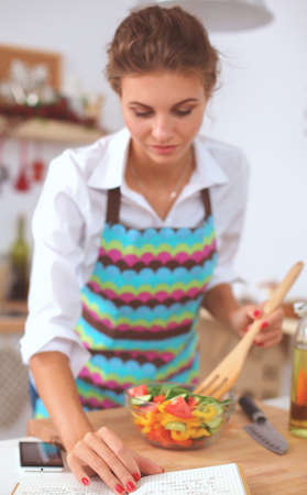 Young woman mixing fresh saladの写真素材