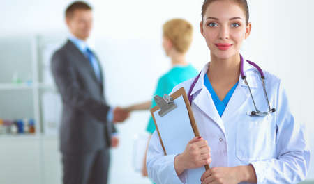 Attractive female doctor in front of medical groupの写真素材