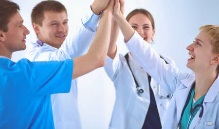 Doctors and nurses in a medical team stacking handsの写真素材