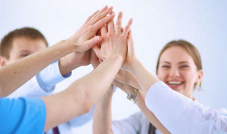 Doctors and nurses in a medical team stacking handsの写真素材