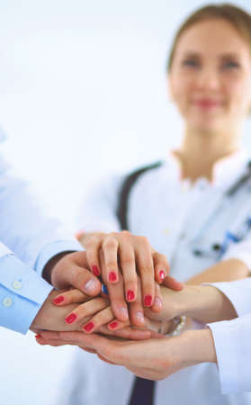 Doctors and nurses in a medical team stacking handsの写真素材