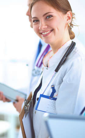 Attractive female doctor in front of medical groupの写真素材