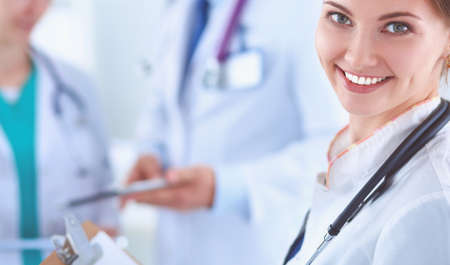 Attractive female doctor in front of medical groupの写真素材