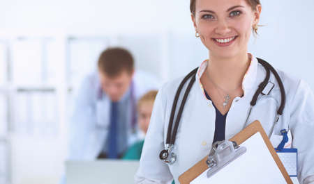 Woman doctor standing with stethoscope at hospitalの写真素材
