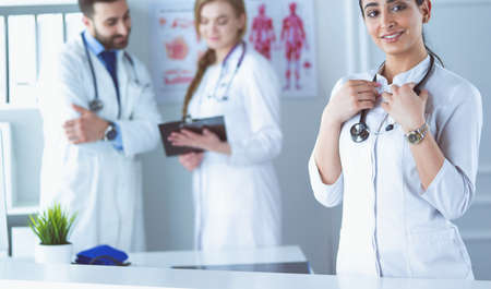 Woman doctor standing with stethoscope at hospitalの写真素材